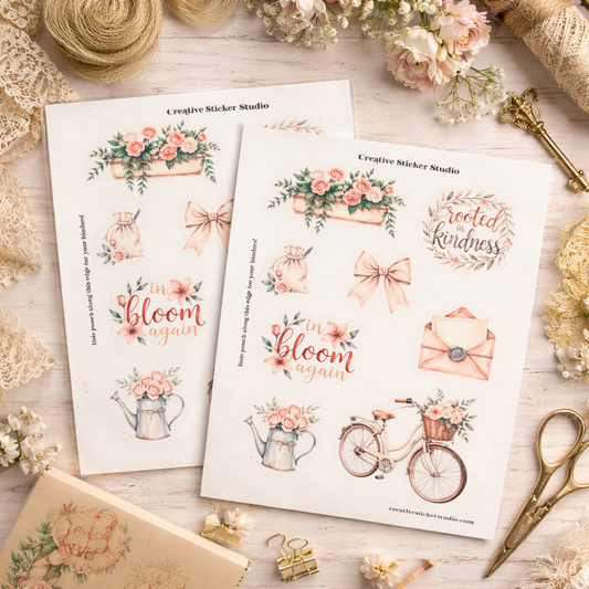 Two sheets of decorative stickers with floral and text designs on a wooden surface with flowers and a key.