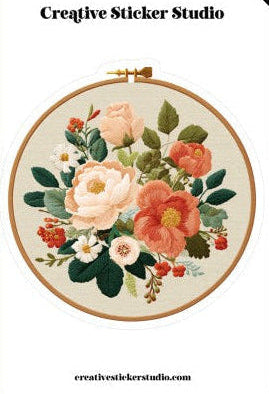 Embroidery hoop with floral design on a white background, featuring 'Creative Sticker Studio' branding.