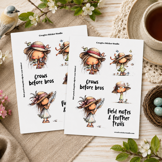 Two printed sticker sheets featuring cute illustrated crows wearing hats, arranged on a rustic beige fabric surface with flowers, a bird, a cup of tea, and a small nest nearby. The sheets include text such as 'Crows before bros' and 'field notes & feather trails,' and the brand 'Creative Sticker Studio' is visible at the top.
