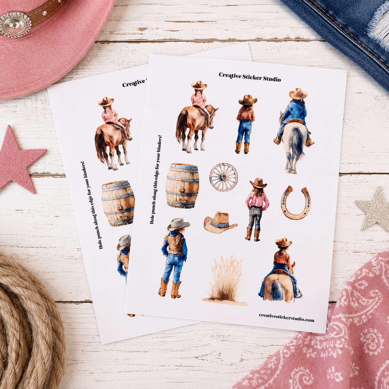 Two sheets of watercolor cowboy-themed stickers displayed on a rustic white wood background with styled western props including a pink hat, denim, rope, and bandana.