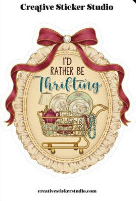 Decorative sticker with text 'I'd rather be thrifting' and a shopping cart design, featuring a red ribbon and pearl accent.